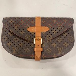 Louis Vuitton
2012 Saumur perforated monogram clutch bag